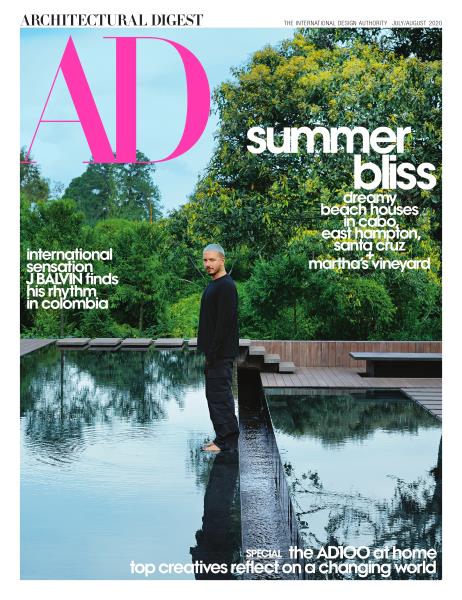 Tom Joyner's elegant villa in Golden Beach, Florida, featuring a serene pool and lush greenery, highlighted in Architectural Digest.